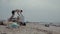 Sporty man doing a somersault using a fitball on the beach