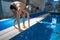 Sporty man in the pool, night workout