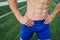 sporty man with pumped up abs in the park while workout exercise lifestyle