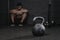 Sporty man sitting at the gym suffering breakdown to overcome. Demotivation sport concept.Stress and fatigue in sport. Crossfit k