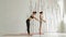 Sporty man and woman doing ashtanga yoga