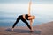 Sporty Middle Aged Woman Practicing Yoga Outdoors, Standing In Triangle Pose