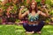 Sporty redhead female relaxing in outdoor summer park.