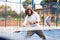 Sporty resolved man playing padel on open court