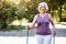 Sporty retired lady in purple top in the park