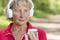 Sporty senior jogger woman listening music from phone