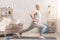 Sporty senior lady doing lunges at home, empty space