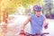 Sporty senior man looking at cycling glove on footpath