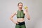 Sporty slim girl holding a green apple in her hands. Fitness model in leggings. Young woman slimming concept