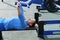 Sporty slim man doing bench press using outdoors gym equipment