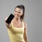 Sporty smiling pretty woman advertising blank mobile phone display at camera