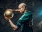 Sporty tattooed, bald fashionable male soccer player posing in a studio for the photoshoot with a soccer ball