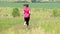 Sporty teenager running on meadow