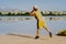 Sporty teenager throwing a stone in the lake