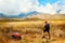 Sporty tourist guy with backpack looking at the mountains. Indonesia. Lombok Island