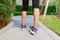 Sporty woman ankle sprain while jogging or running at park.