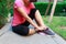 Sporty woman ankle sprain while jogging or running at park.