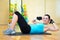 Sporty woman doing exercises for abdominal muscles in gym