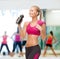 Sporty woman drinking water from sportsman bottle