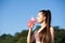 Sporty woman drinking water during training