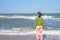 Sporty woman with flying hair is standing in the surf