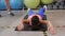 Sporty woman lying on mat and doing abs in gym