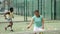 Sporty woman and other athletes training on the tennis court