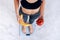 Sporty woman with a perfect body measuring body weight on electronic scales and holding a yellow banana and a red apple