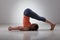 Sporty woman practices yoga asana Halasana