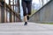 Sporty woman running on an old boardwalk bridge