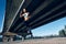 Sporty woman running outdoors under city bridge