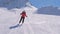 Sporty woman skis carving down the slope in the mountains ski resort at winter