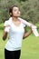 Sporty woman take a breath while stretching using towel