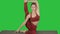 Sporty yogi girl doing fitness practice, stretches, yoga asana Parivritta Kraunchasana, Heron Pose on a Green Screen