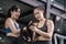 Sporty young asian women training boxer preparing strap on wrist with coach trainer