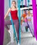 Sporty young woman doing aerial yoga asanas with suspended hammock