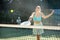 Sporty young woman playing padel on open court on summer