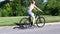 Sporty young woman riding bike outdoor. Active woman riding bicycle on the park.