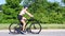 Sporty young woman riding bike outdoor. Active woman riding bicycle on the park.