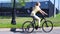 Sporty young woman riding bike outdoor. Active woman riding bicycle on the park.
