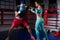 Sporty young woman in sportswear and in boxing gloves training w