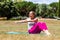 Sporty young woman toning up her arms in park