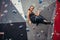 Sporty young woman training in a colorful climbing gym. Free climber girl climbing up indoor