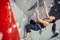 Sporty young woman training in a colorful climbing gym. Free climber girl climbing up indoor