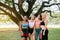 Sporty young women in fitness clothes friendly team taking a break after workout at public park,Woman resting after exercising ses