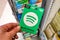 Spotify green gift cardof premium subscription in a hand at store over gift cards