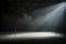 spotlight on empty stage with ballet barre