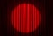 Spotlight illuminating closed red stage curtains. Start of performance