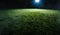 Spotlight shining on empty sports field at night