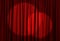Spotlights illuminating red stage curtains. Start of performance